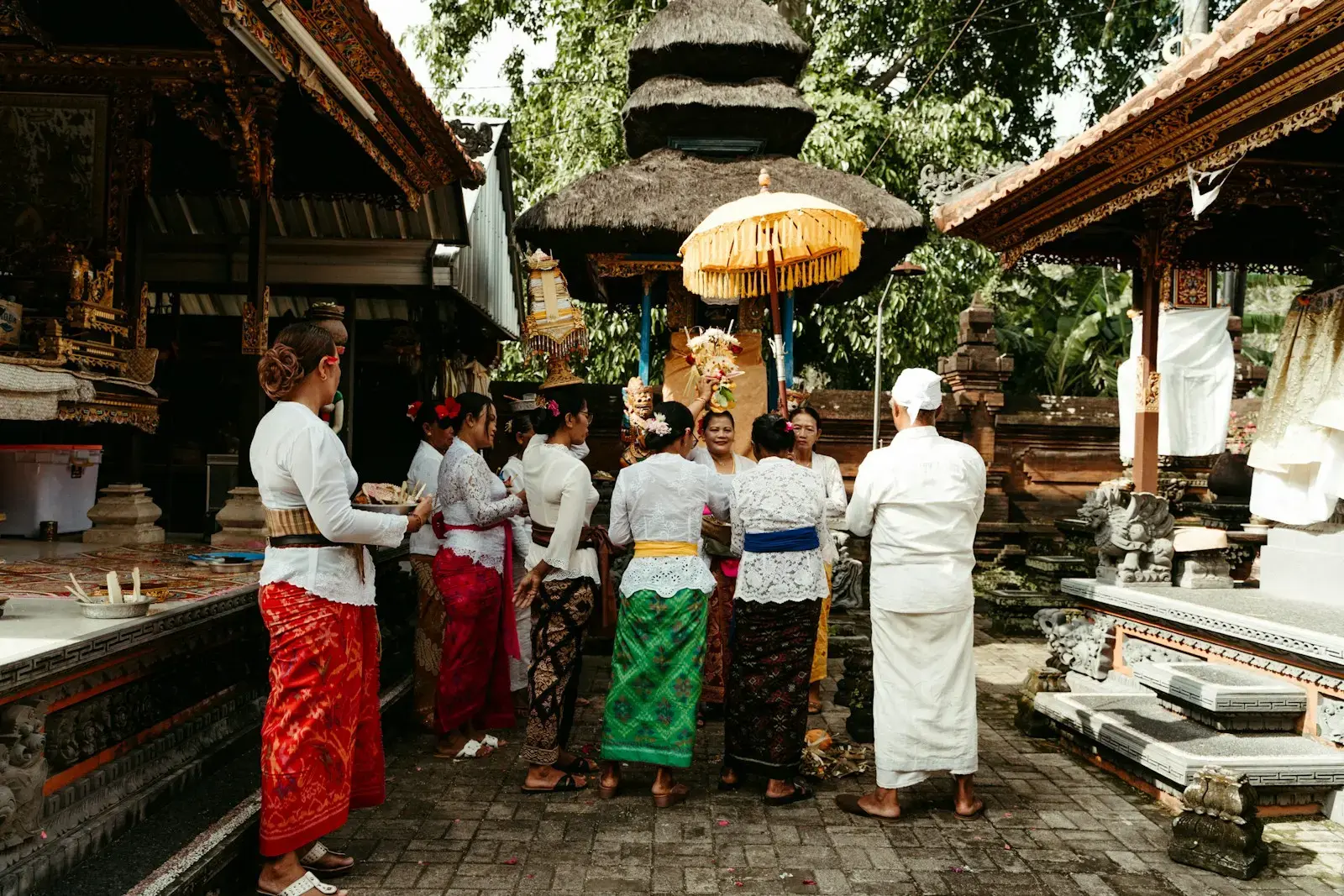People in traditional attire gathered at a temple entrance