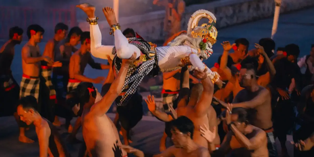 Dancers perform a traditional ritual with torches at night.