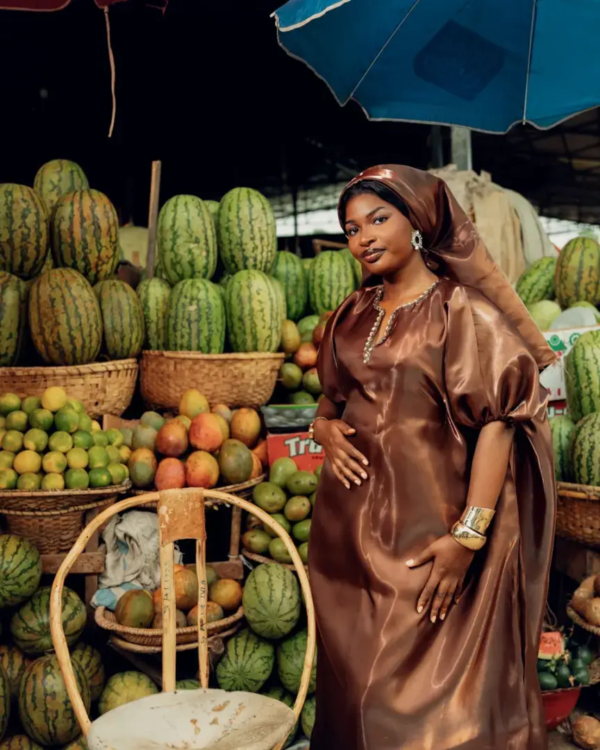 Woman in brown dress at a fruit market