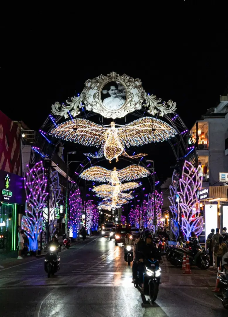 Photo by Maksim Shiriagin Street illuminated with festive angel lights at night