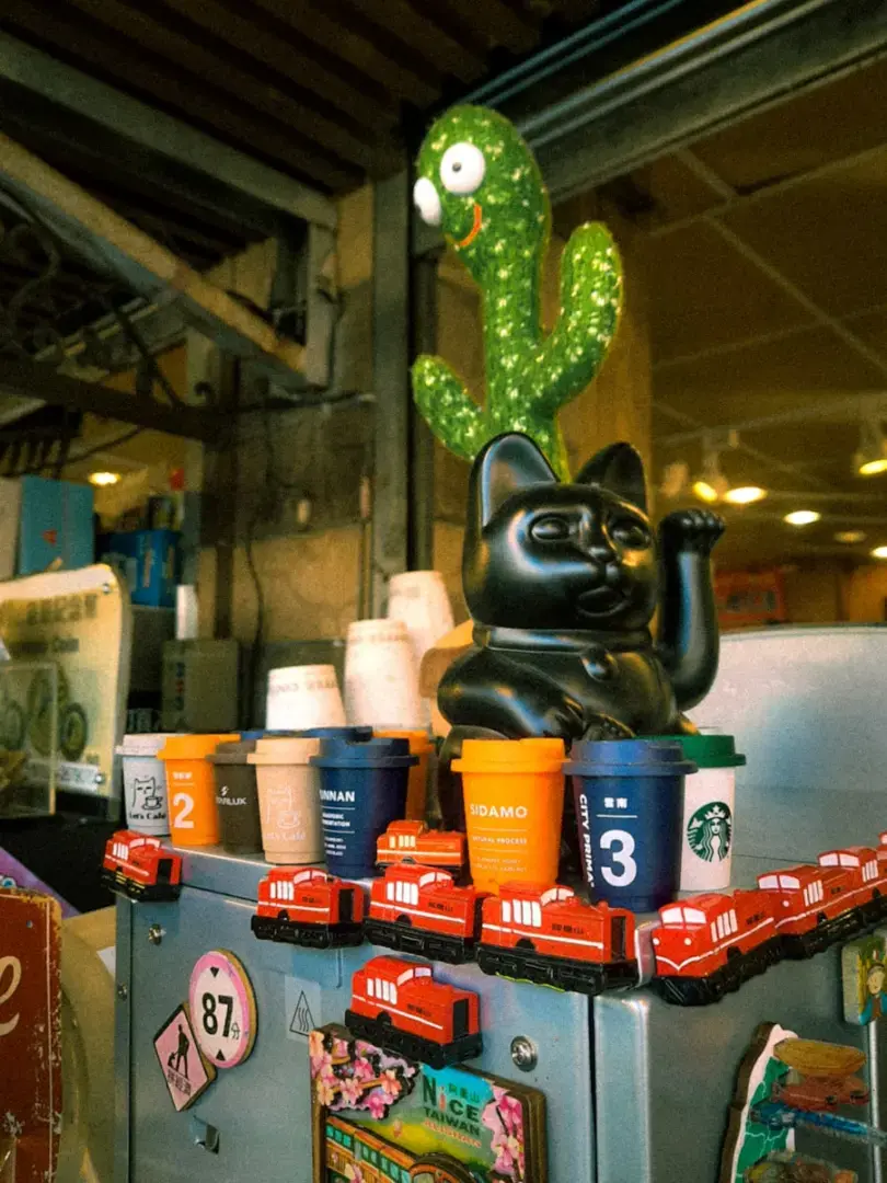 Black cat figure with cactus and coffee cups