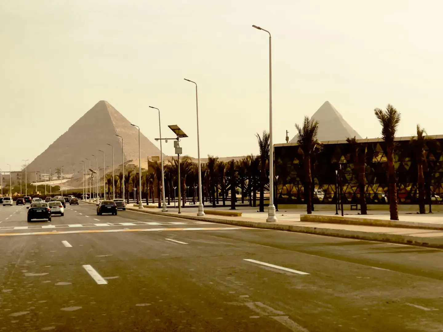 Photo by Mohamed Marey The great pyramids of giza seen from a street.