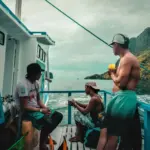 People enjoy a boat ride on a tropical day.