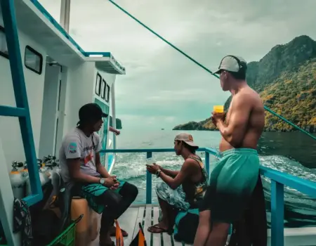 People enjoy a boat ride on a tropical day.