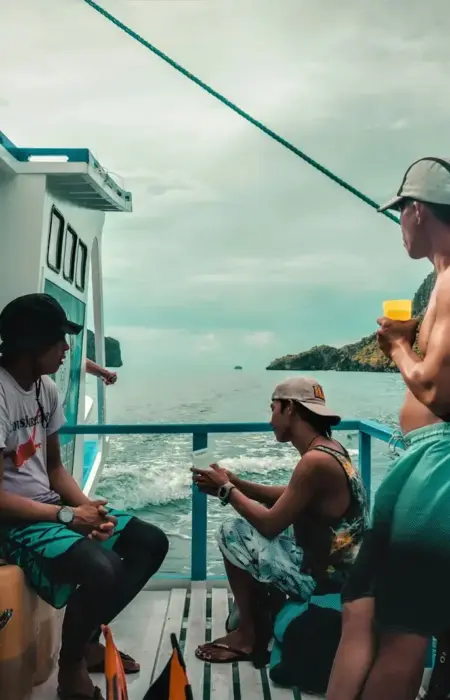 People enjoy a boat ride on a tropical day.