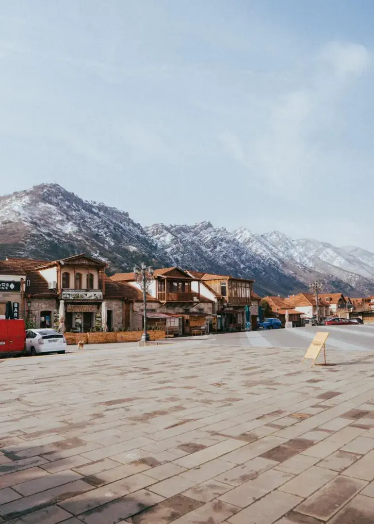 Quaint Mtskheta town with historical charm nestled under snow-capped Caucasus Mountains.