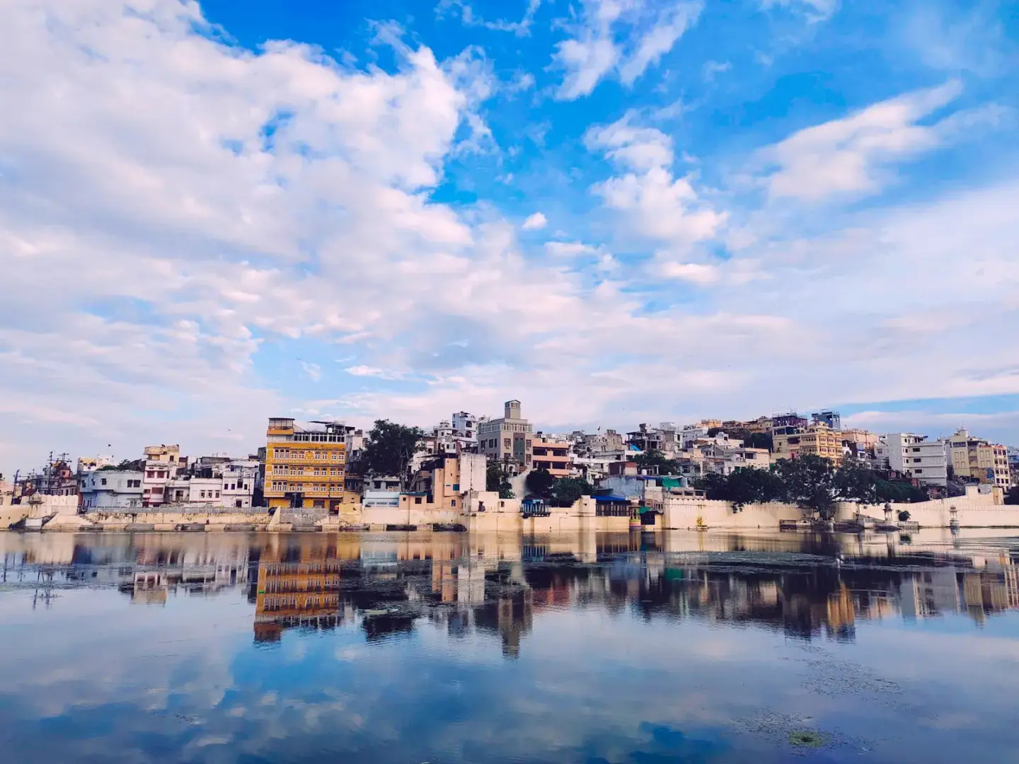 a body of water with a city in the background
