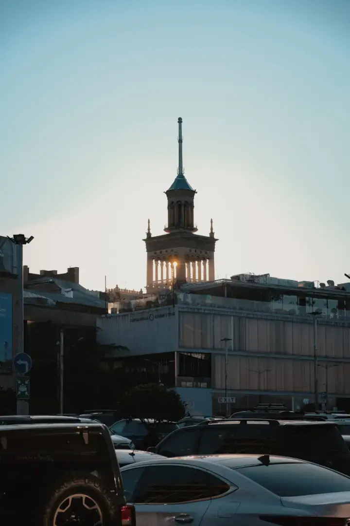 Photo by Alina Scheck A tall tower building silhouetted against the sky.