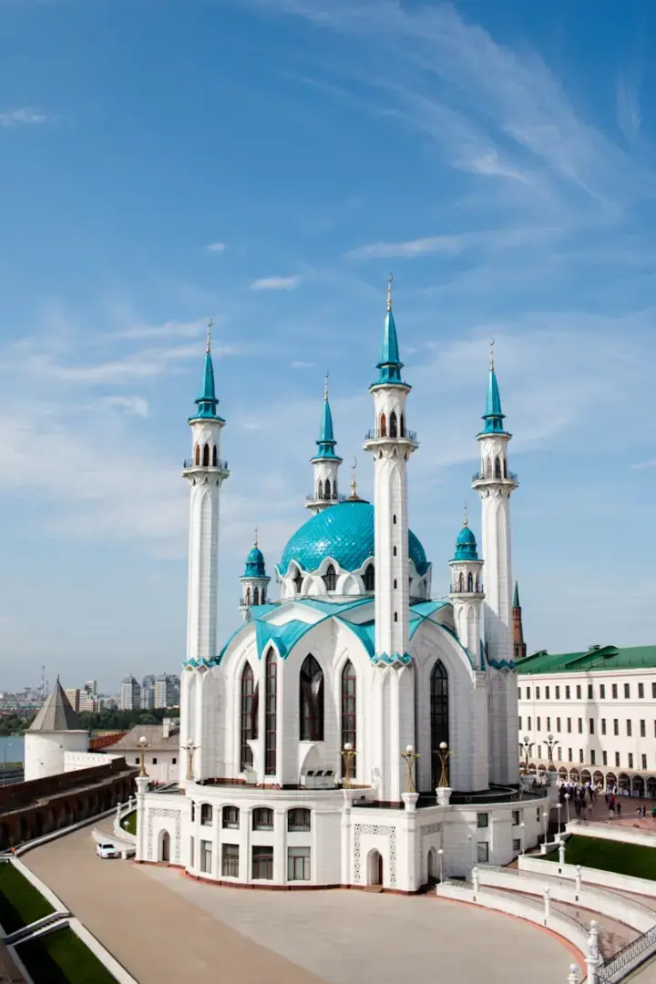 Photo by Elina Sitnikova white and green concrete building under white clouds during daytime