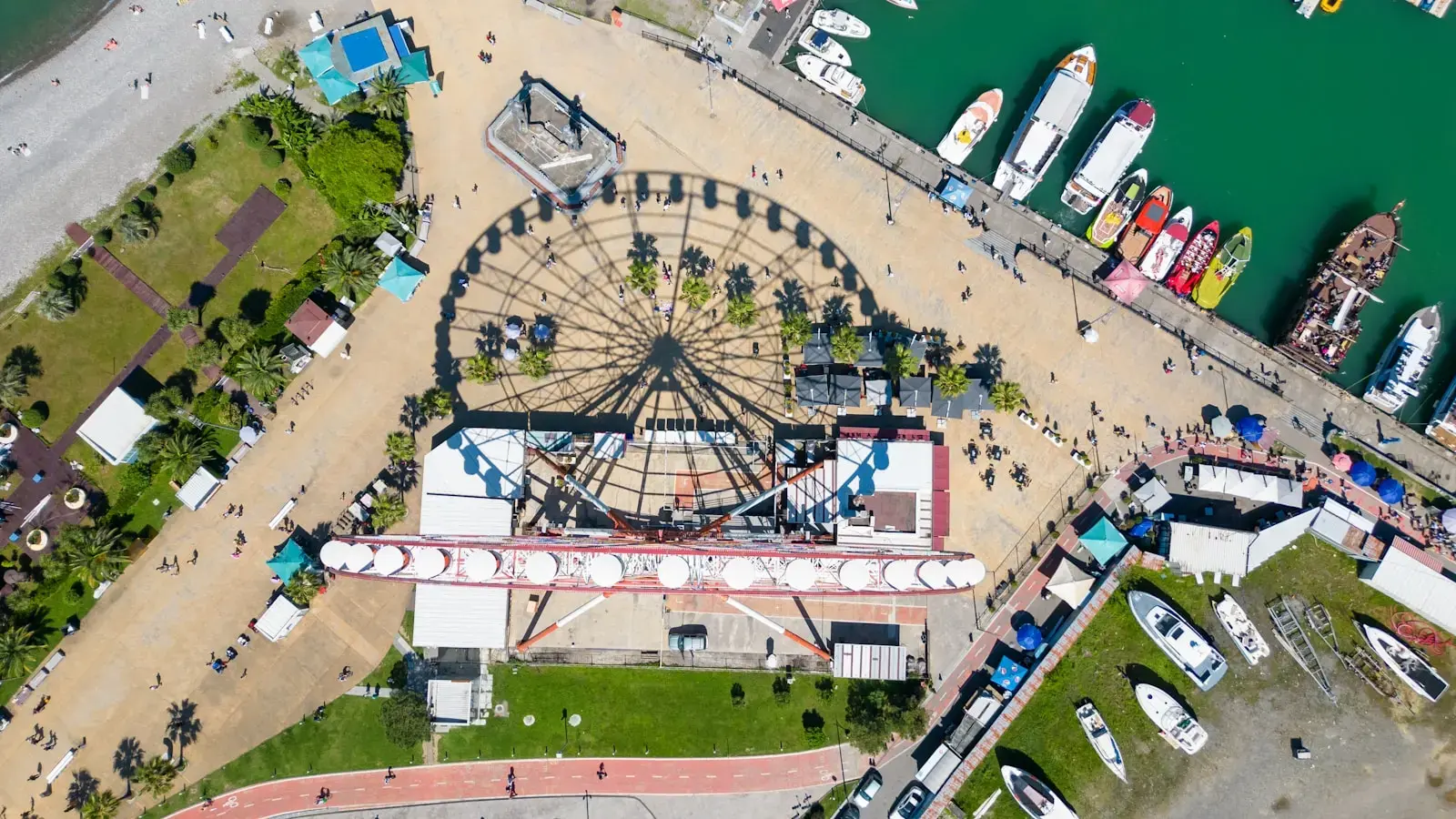 Photo by Aleksandr Galichkin Aerial view of a ferris wheel by the harbor
