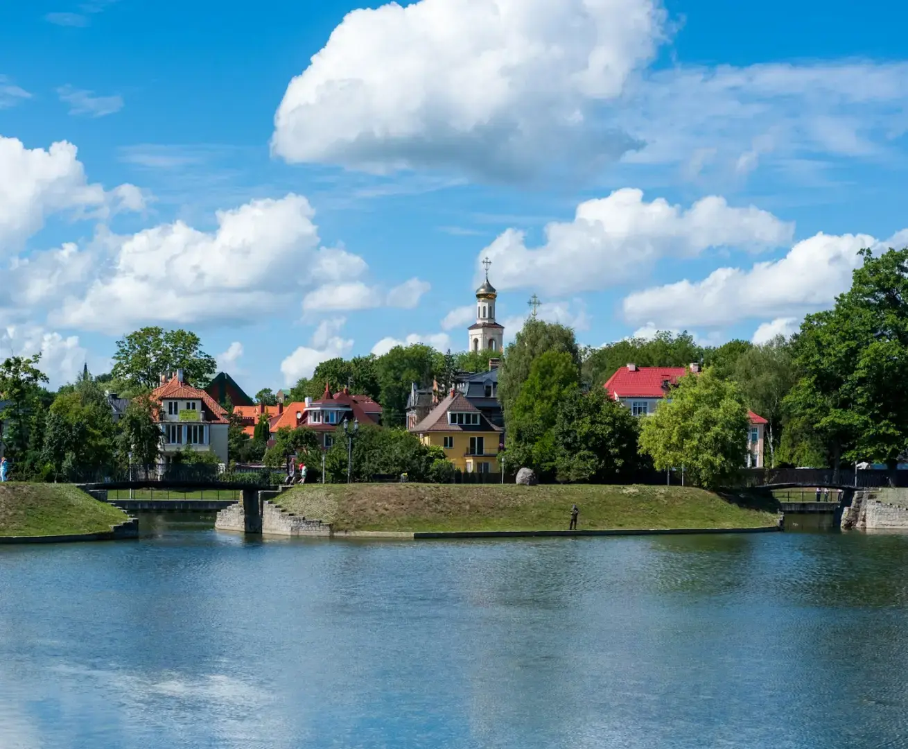 Photo by Alexander Awerin a body of water with houses in the background