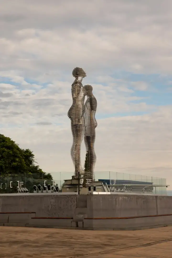 Photo by Maria Baranova A statue of two people standing next to each other