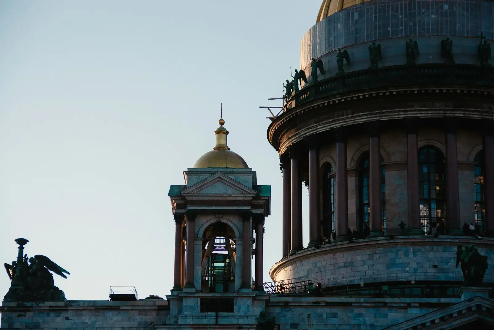 Photo by Michael Rebrikov Ornate building with a large golden dome and smaller cupola.