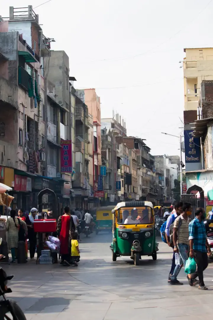 a group of people walking around a busy street