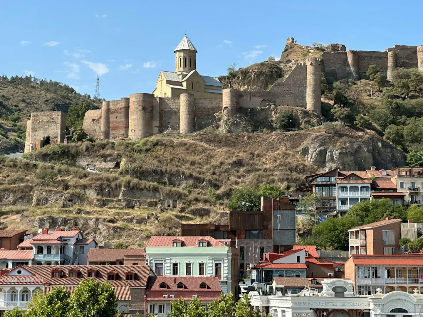 a city with a castle on top of a hill