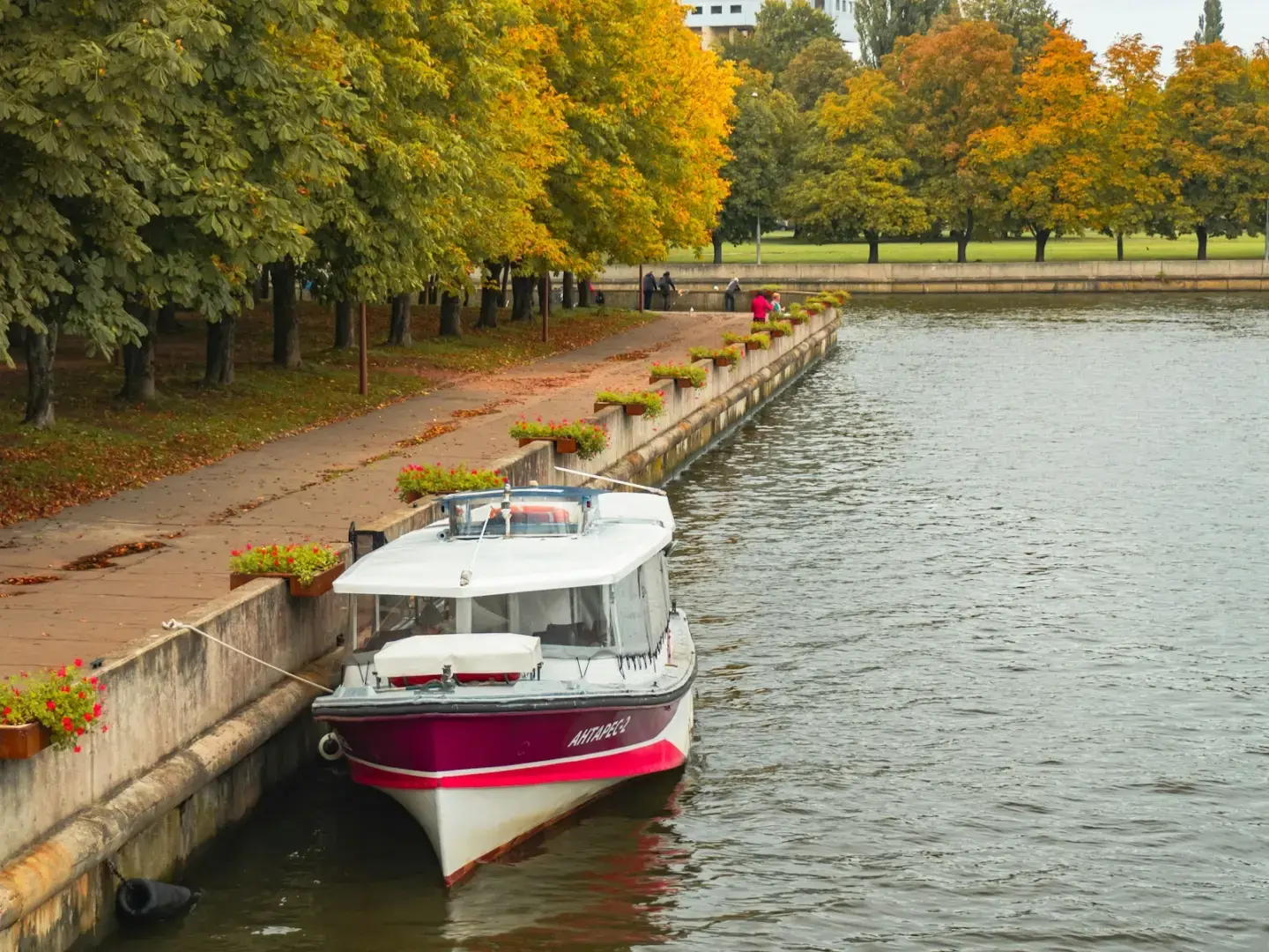 Photo by Юрий Баринов a red and white boat is docked at a dock