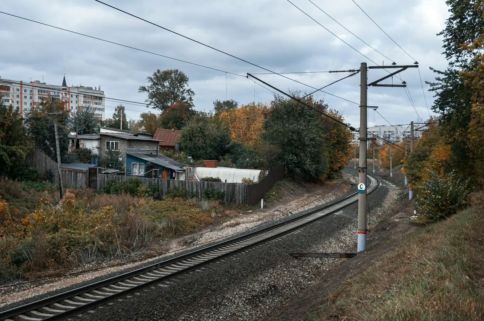 Photo by lev p a view of a train track with houses in the background