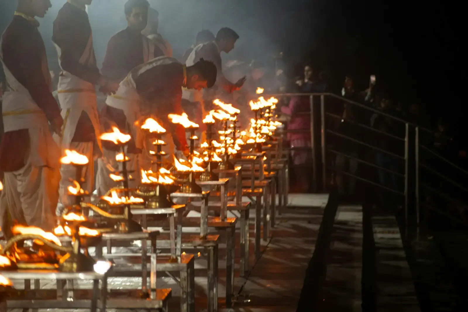 A group of people standing around a table covered in fire