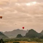 A group of hot air balloons flying in the sky