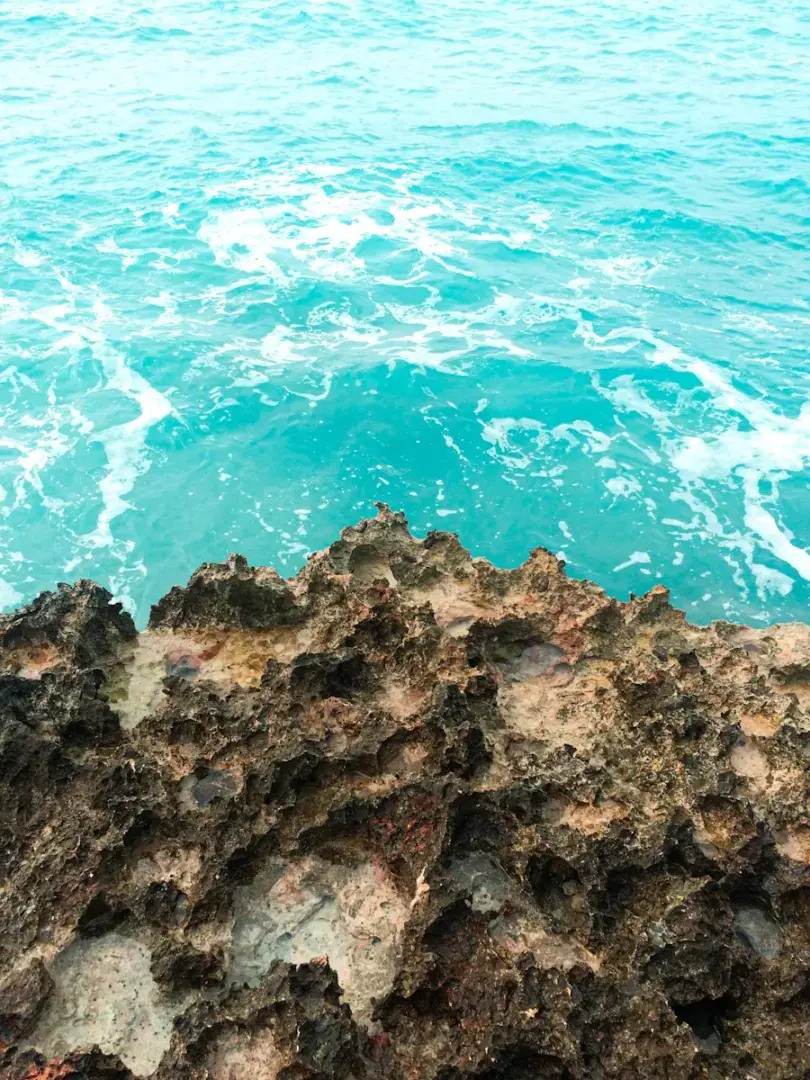Photo by Lucas Kovačević a view of the ocean from a rocky outcropping