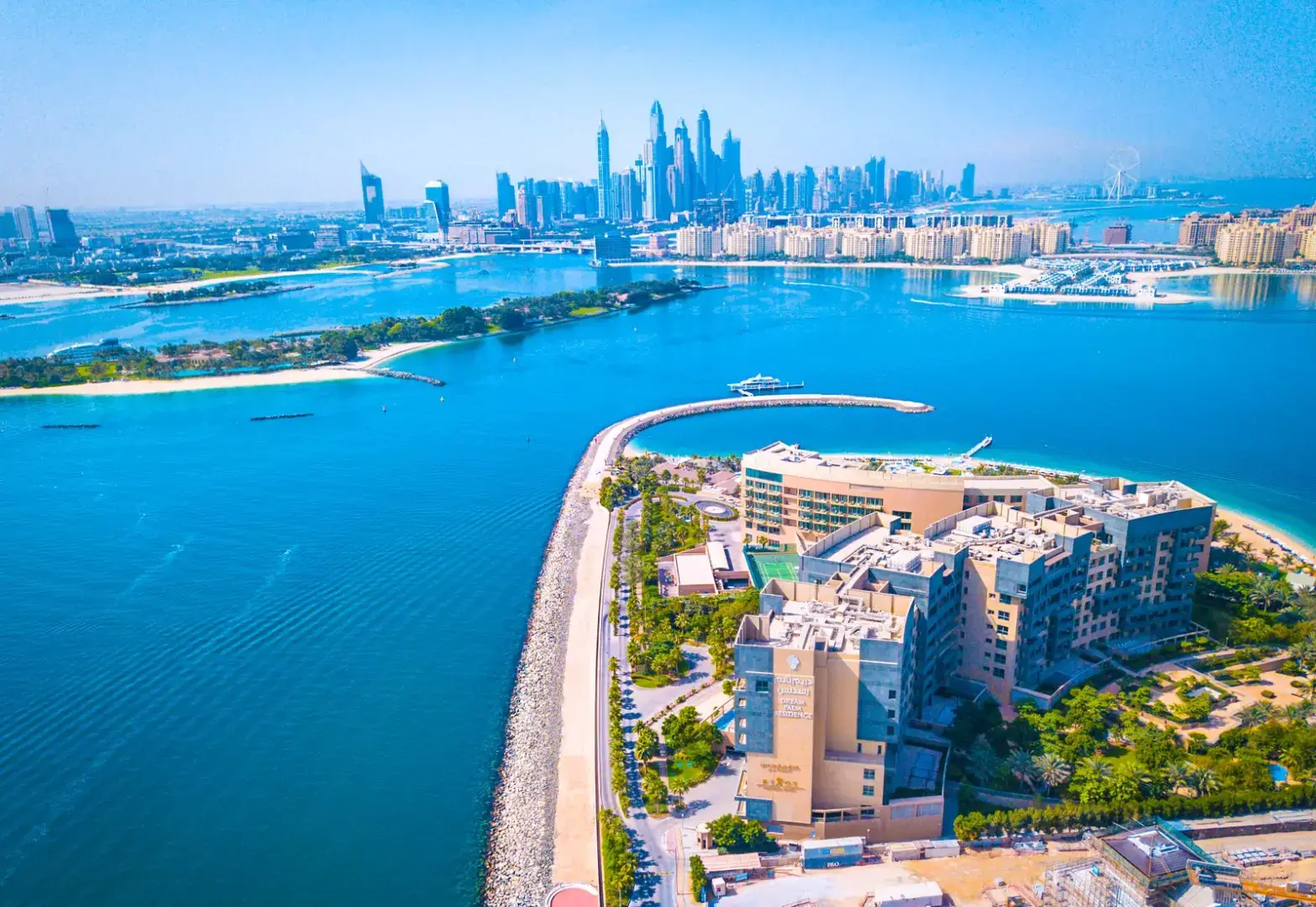 Photo by The Lazy Artist Gallery Experience the vibrant Dubai skyline with a breathtaking waterfront aerial view, showcasing modern architecture and urban beauty.