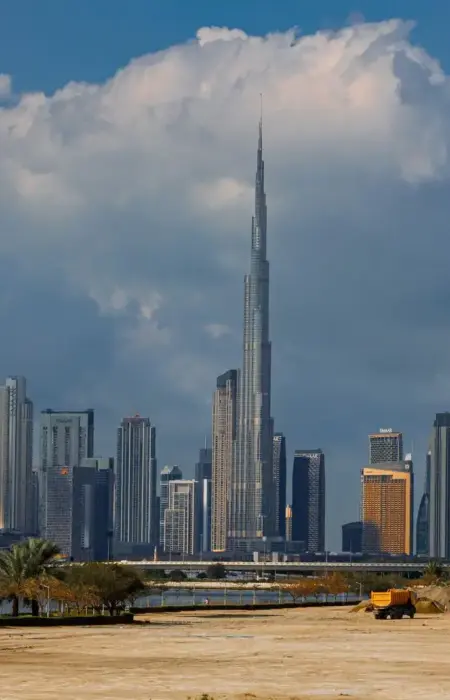 A breathtaking view of the Burj Khalifa towering over the stunning skyline of Dubai under dramatic clouds.