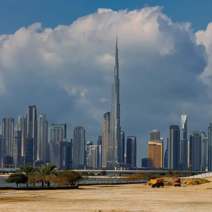 A breathtaking view of the Burj Khalifa towering over the stunning skyline of Dubai under dramatic clouds.