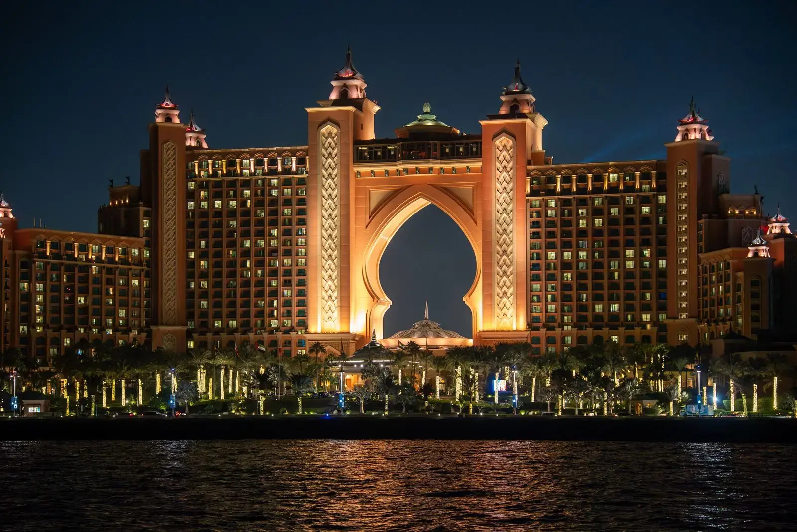 Stunning night view of Atlantis The Palm hotel in Dubai, UAE, glowing with warm lights.