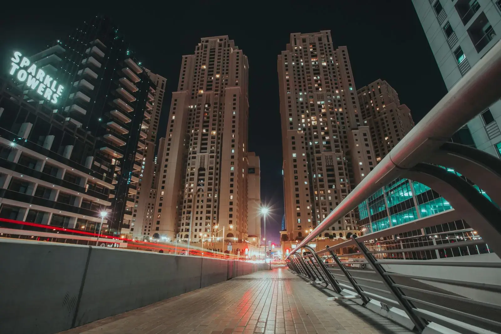 Dynamic cityscape of Dubai at night featuring skyscrapers and bustling streets.