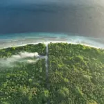 An aerial view of a tropical island in the ocean