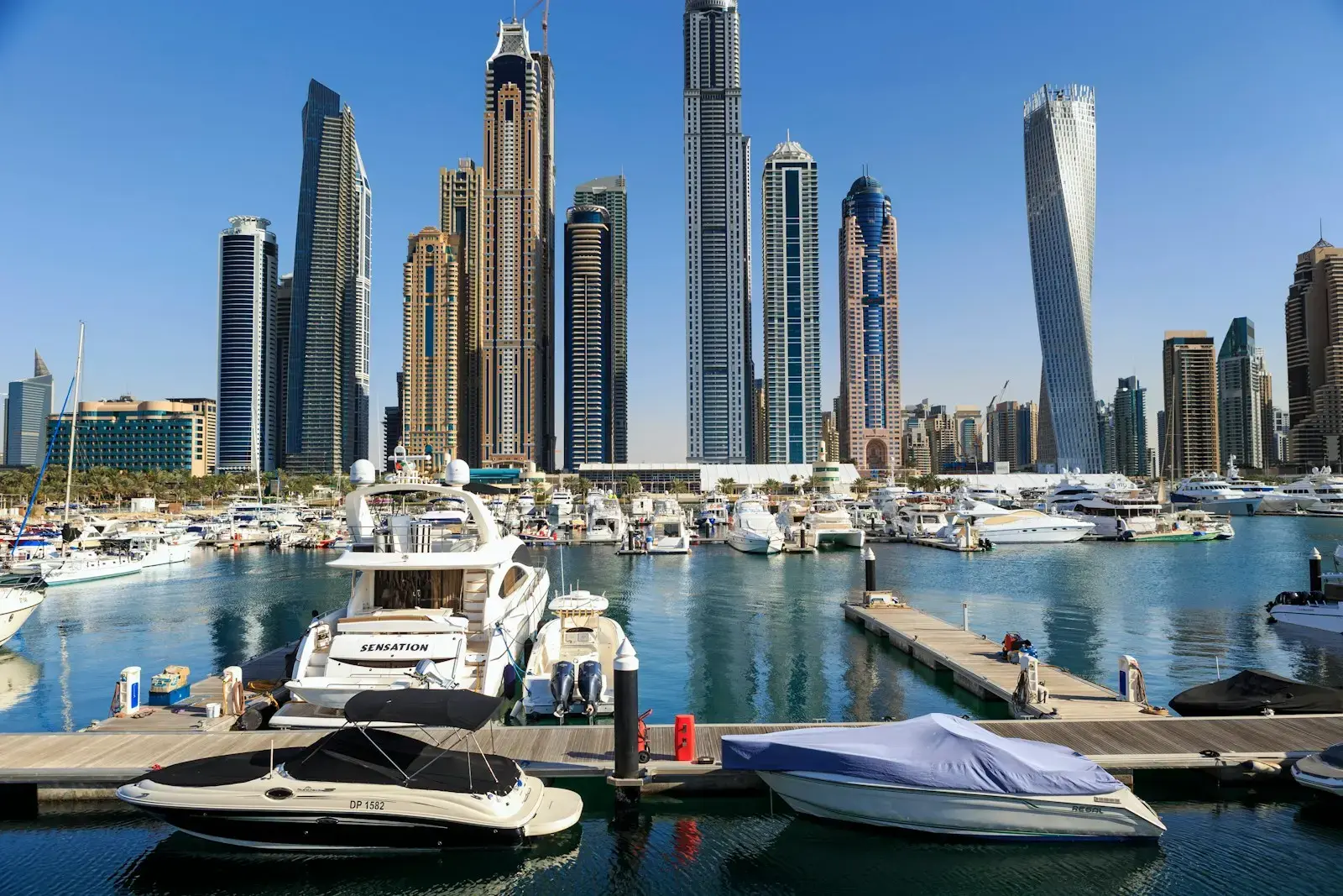 Photo by martin bennie Boats and skyscrapers line a beautiful harbor.
