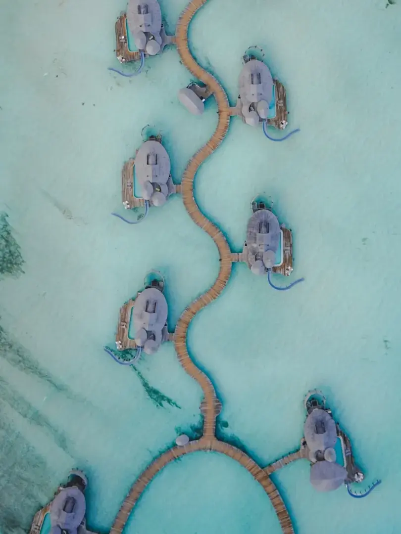 Overwater bungalows are connected by wooden walkways