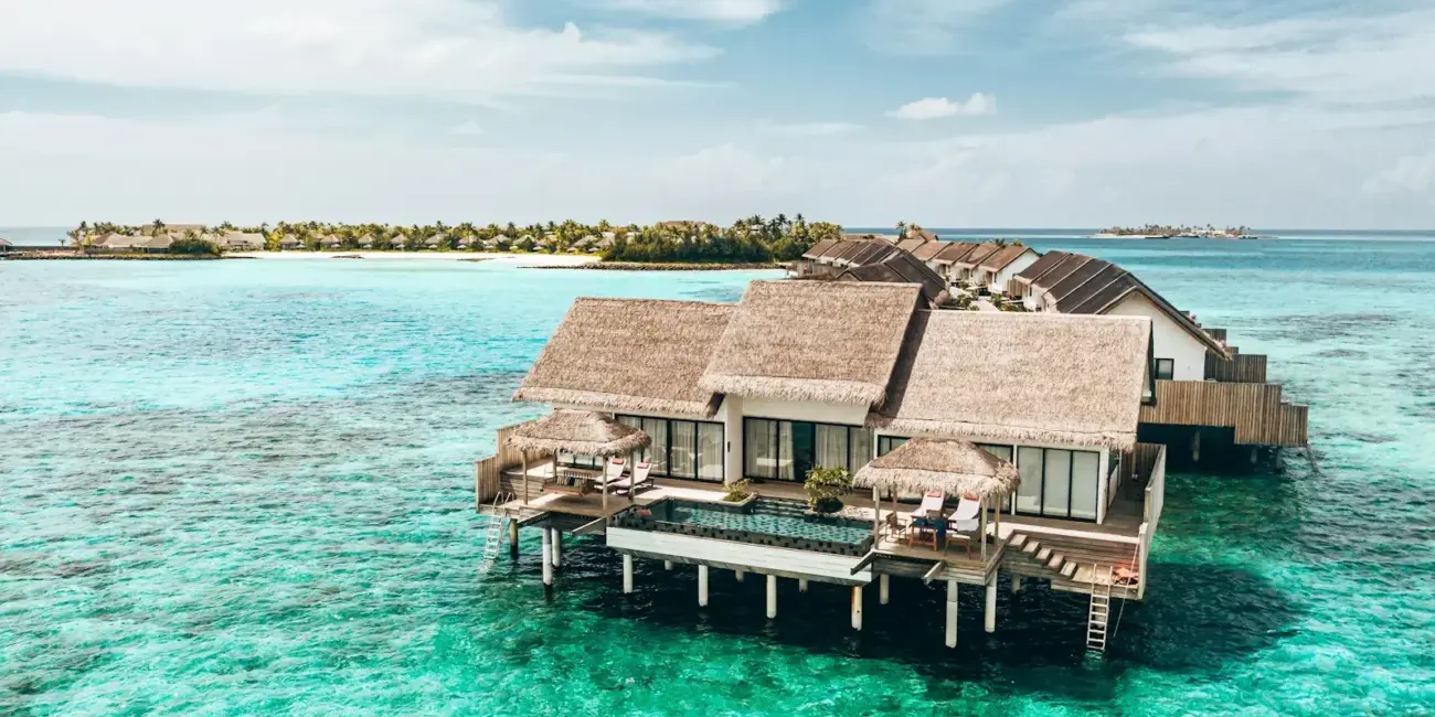 a couple of houses sitting on top of a body of water