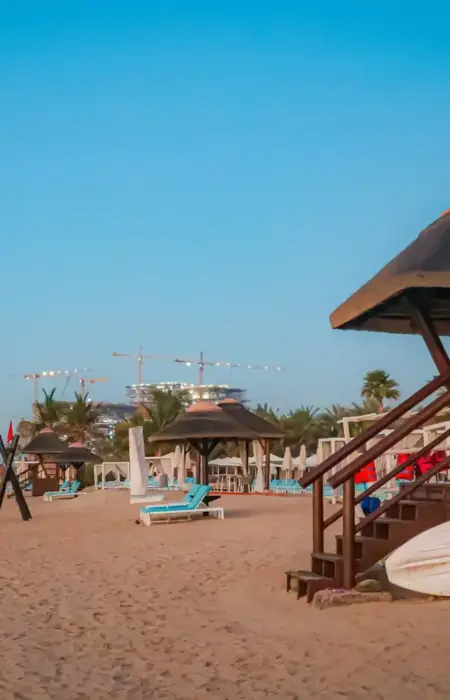 Beach with lifeguard station and resort in the background.
