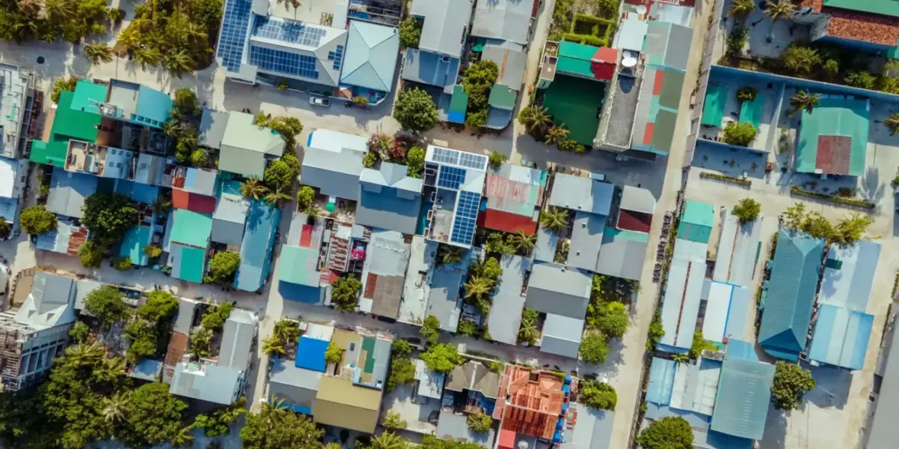 Aerial view of a tropical island village with colorful roofs