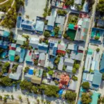 Aerial view of a tropical island village with colorful roofs