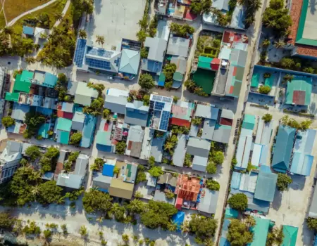 Aerial view of a tropical island village with colorful roofs